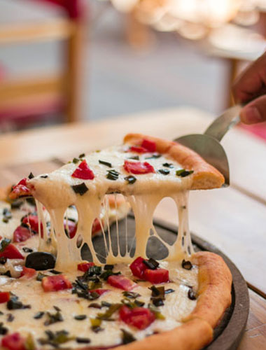 Freshly prepared pizza at Rasika Restaurant